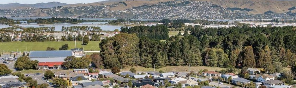 Aerial view of Wainoni residential streets, reserve and the Port Hills in the distance