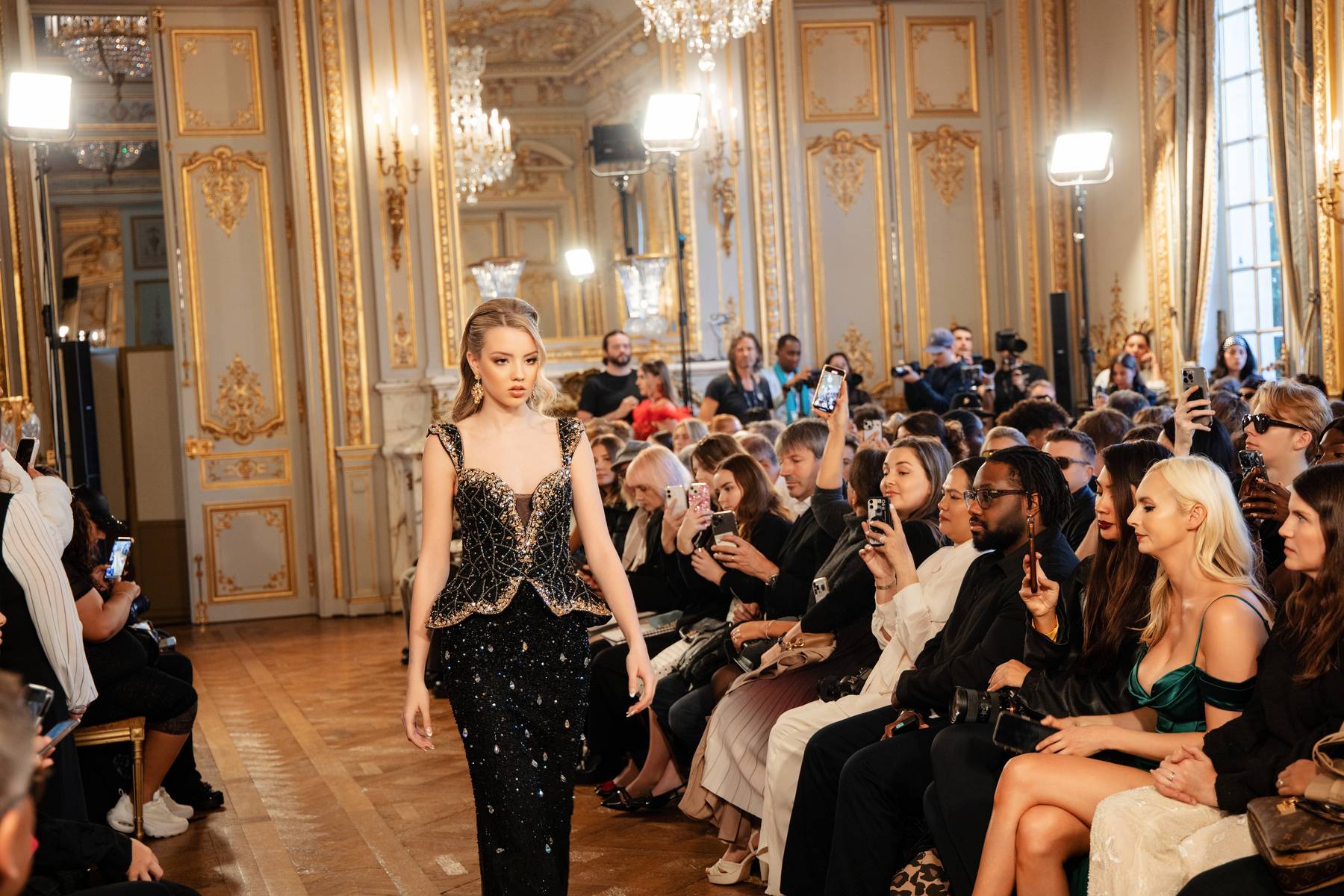 Belle Le Chic model walking the gilded runway in Paris