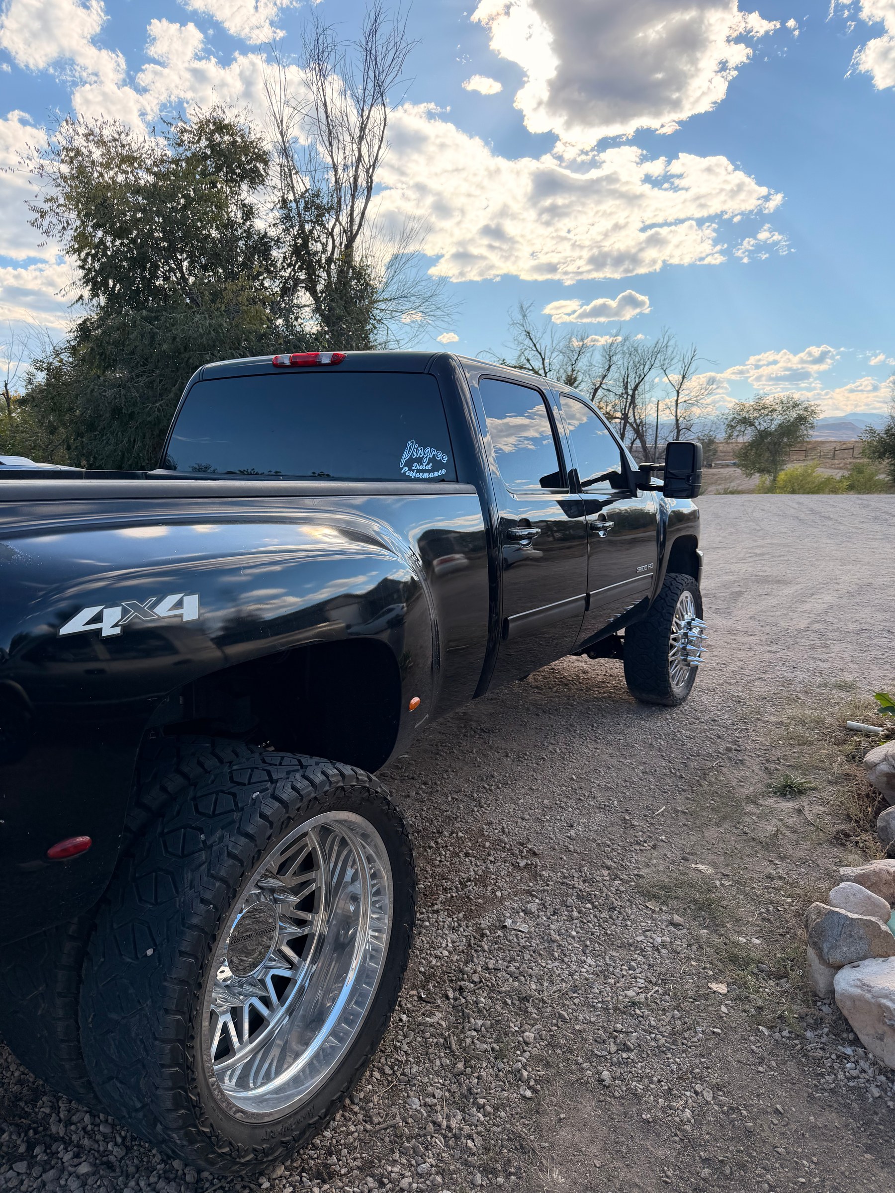 Rear-quarter view of a black pickup with Pingree lettering on the rear glass.