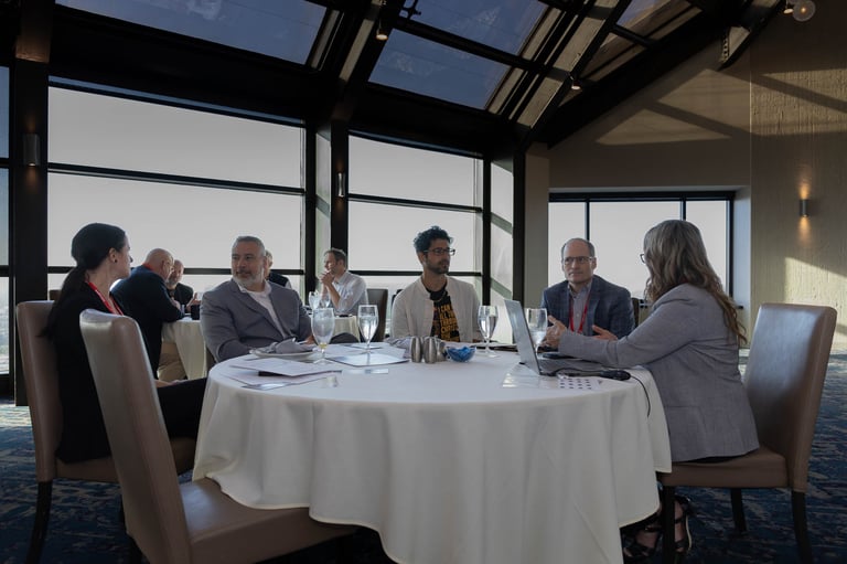 Attendees in conversation around a round table at the Indianapolis emPower Breakfast.