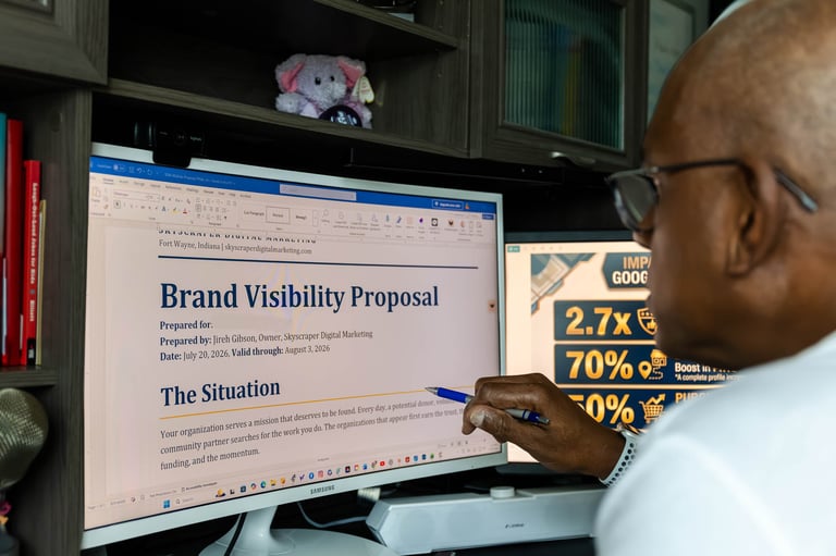 Jireh Gibson reviewing a brand visibility proposal on a computer monitor.