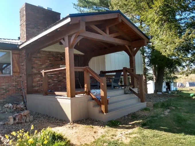Precut timber frame entry porch kit with king post truss and railings in Rutledge, TN