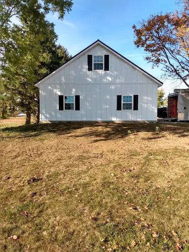 Gable end elevation of white board and batten custom home in Grainger County, TN