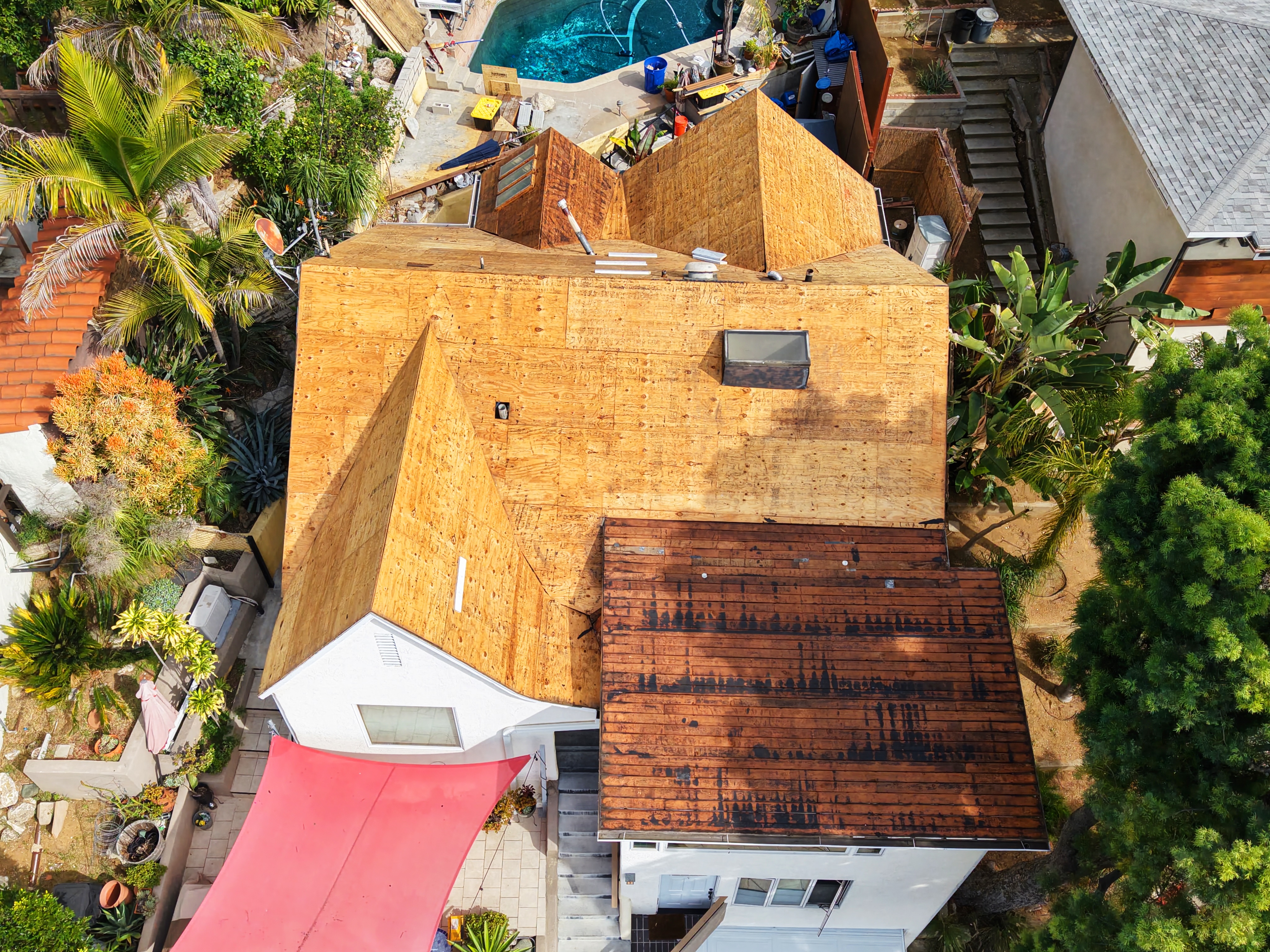 Roof deck preparation: complete tear-off exposing clean wood decking at a Los Angeles residence by UV Roofing