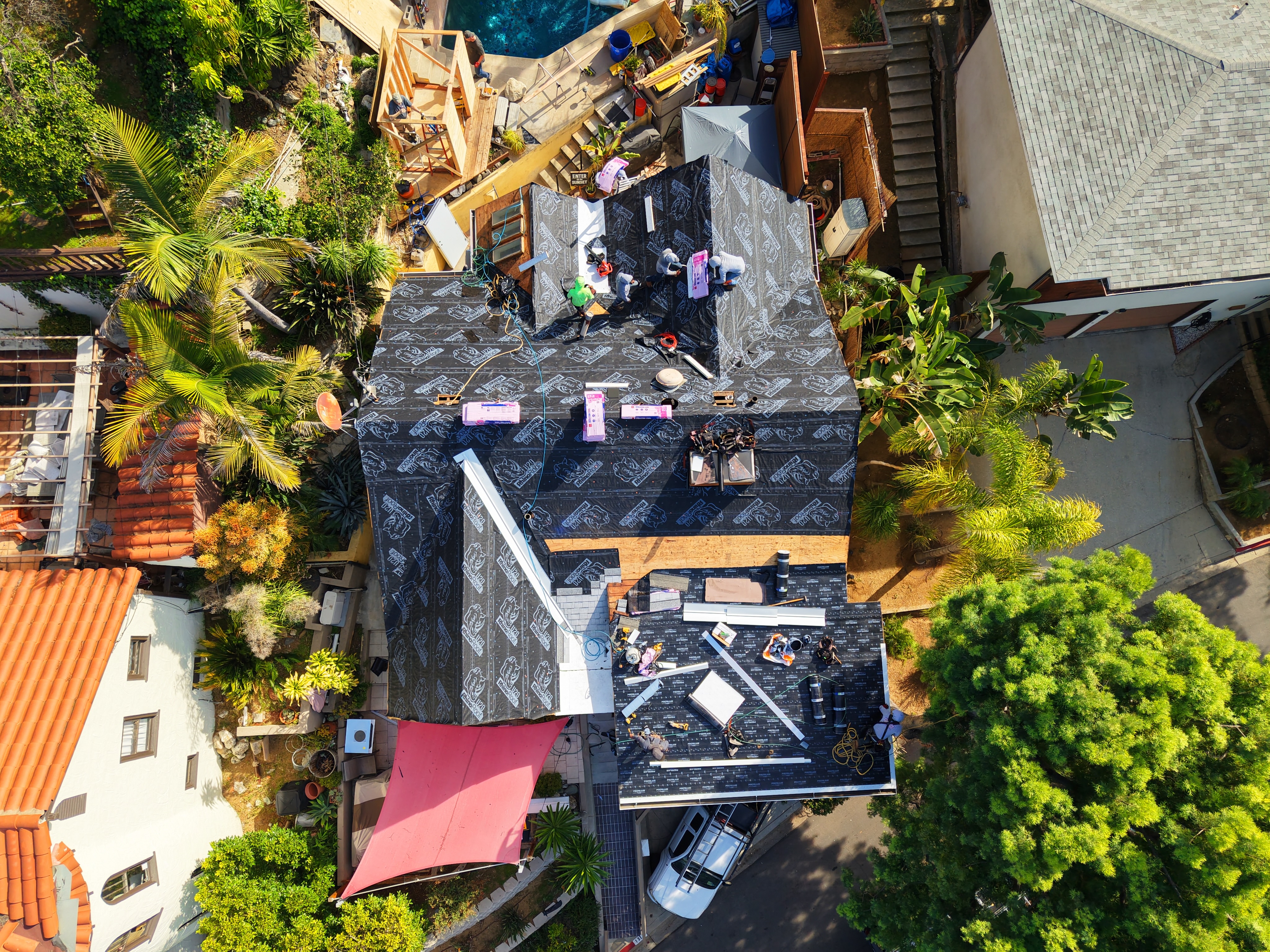 Protective underlayment installation: high-grade synthetic underlayment applied over roof decking by UV Roofing crew