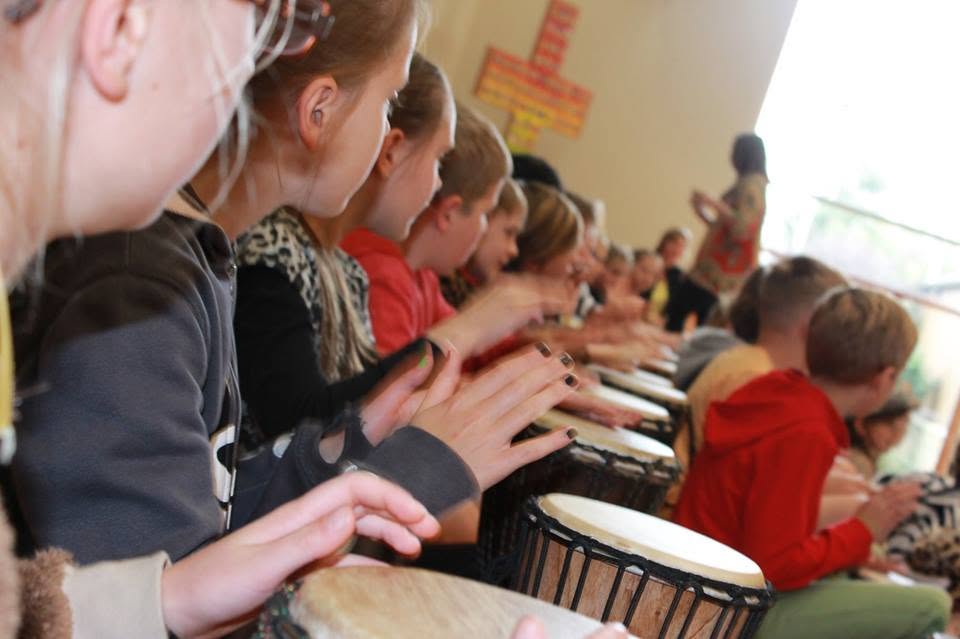 Students drumming together in a school hall during an African Beat incursion