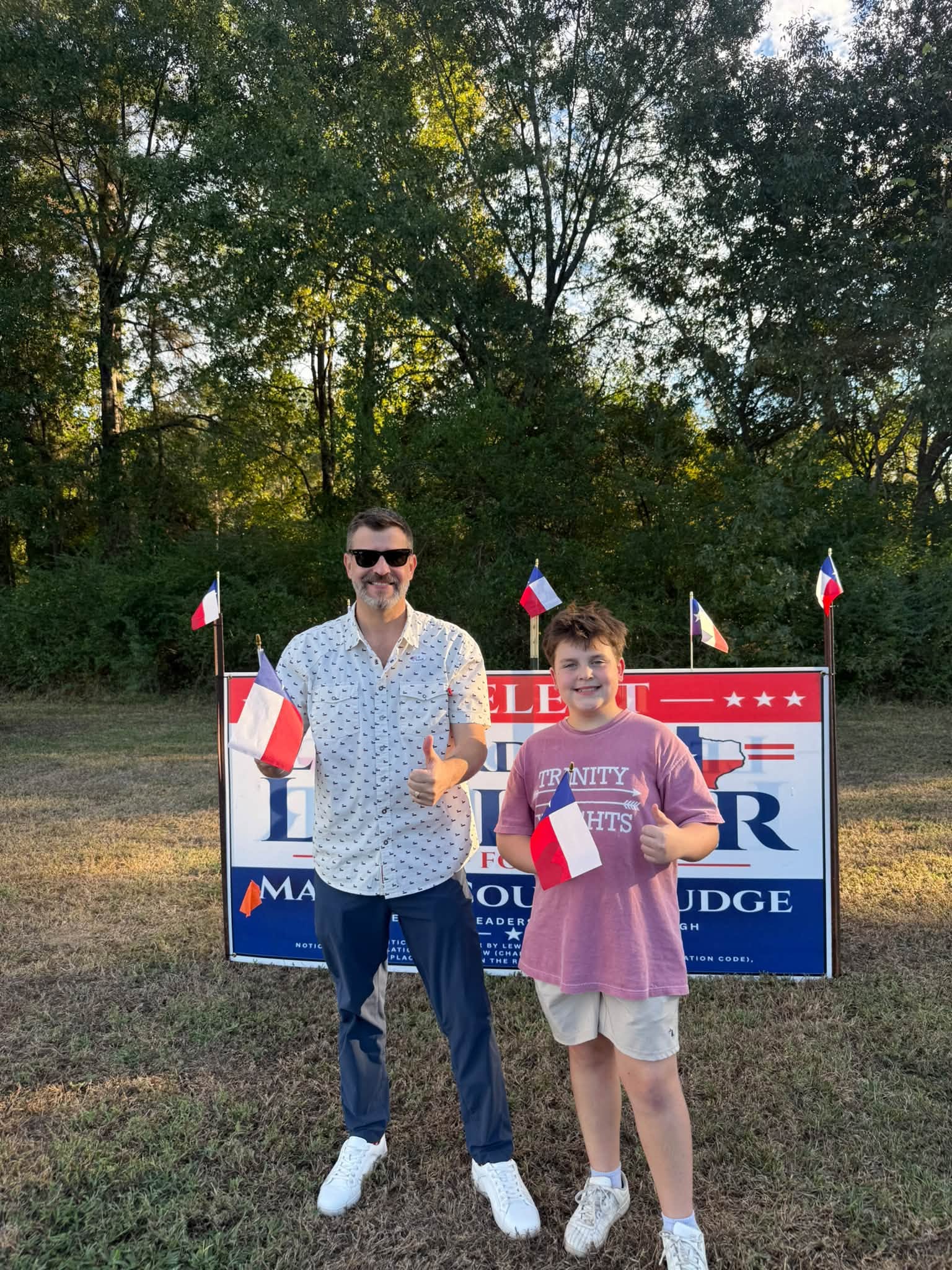 Leward LaFleur with his son by the campaign sign