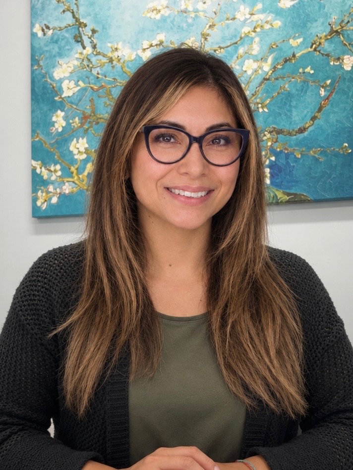 Elizabeth Mojica smiling warmly in her practice