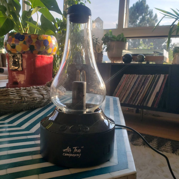 The Air Tea Kettle beside a record player.