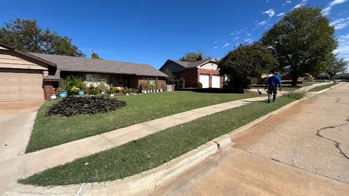 Freshly mowed front lawn and clean edging along the sidewalk and curb