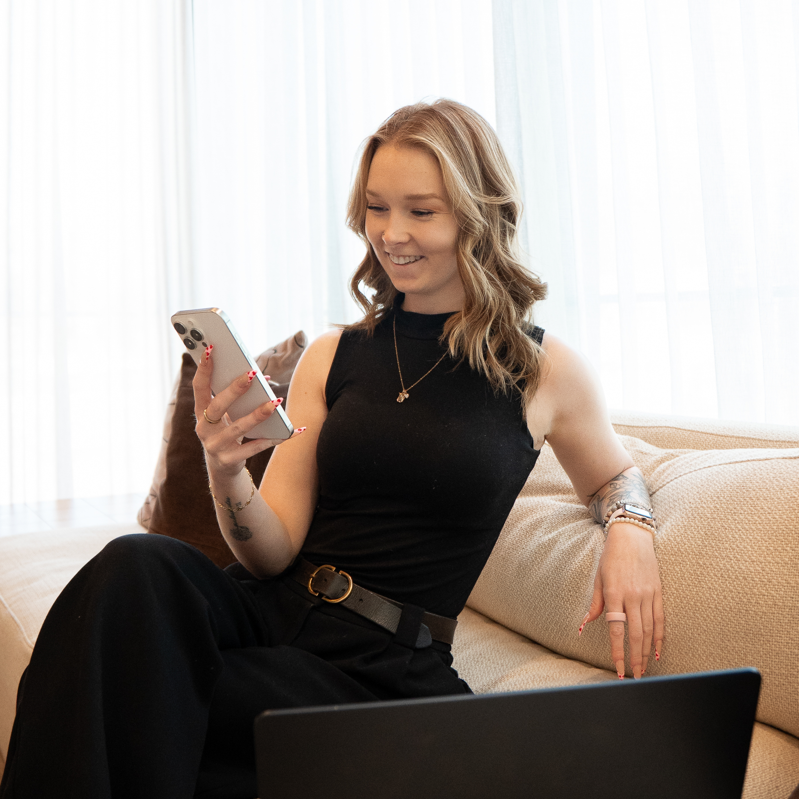 Content strategist planning and editing social media posts on a laptop and phone