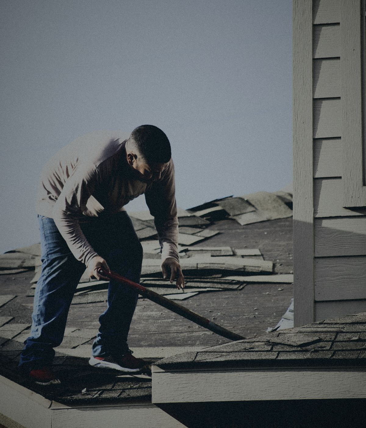 Roofer installing shingles on a residential roof
