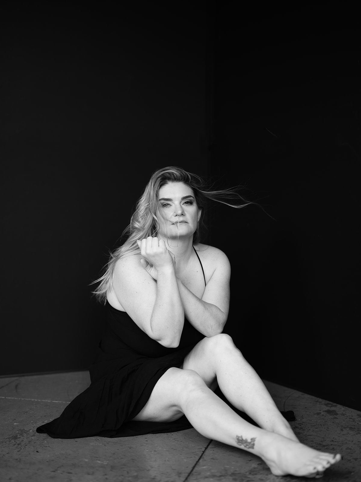 Black and white seated studio portrait of a woman by Elisa Mitchell Studios