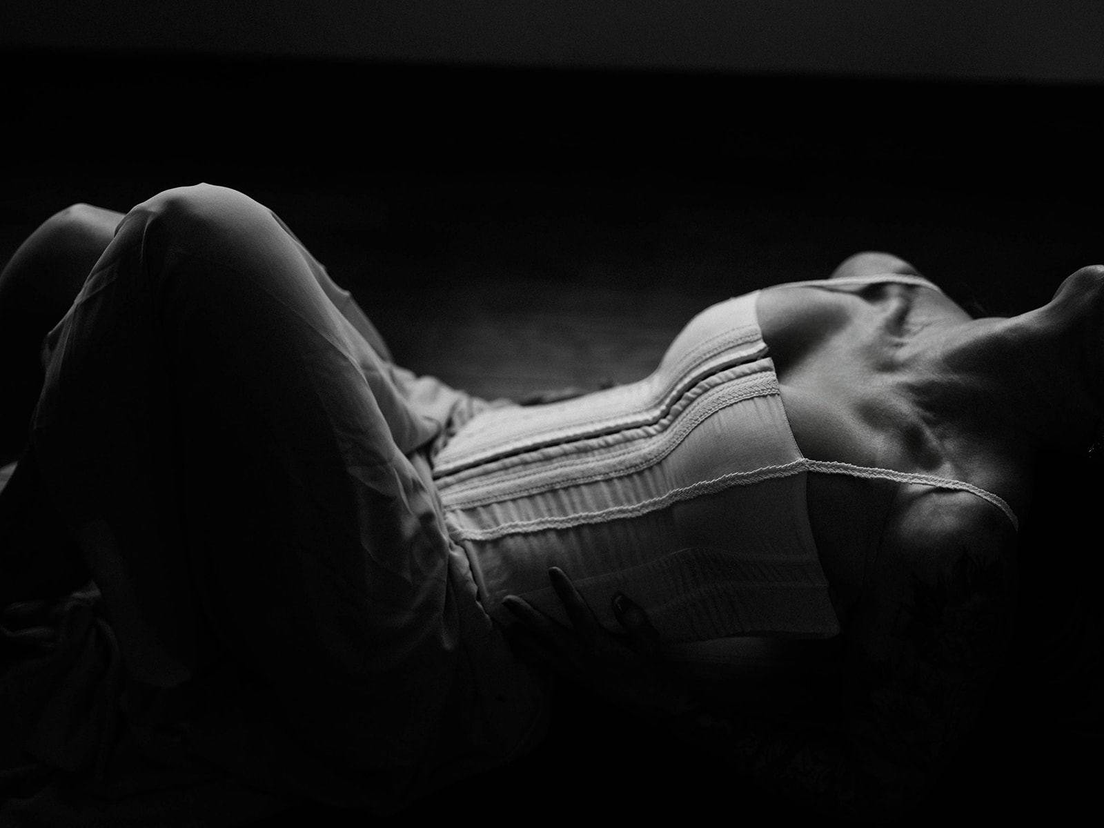 Horizontal black and white portrait of a woman in a corset by Elisa Mitchell Studios