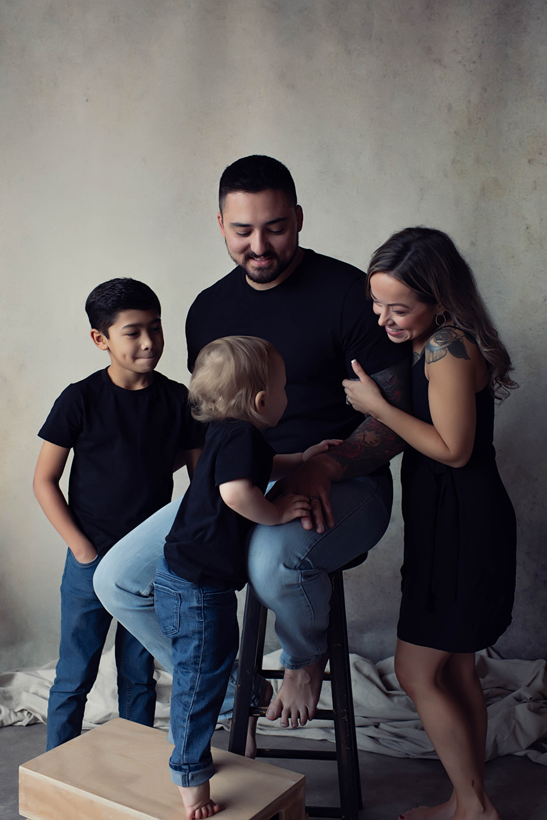 Studio portrait of a young family in casual black by Elisa Mitchell Studios