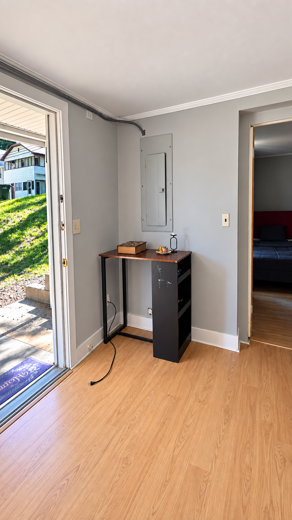 Common entry living space with exterior door and view toward bedroom at 137 Garfield St