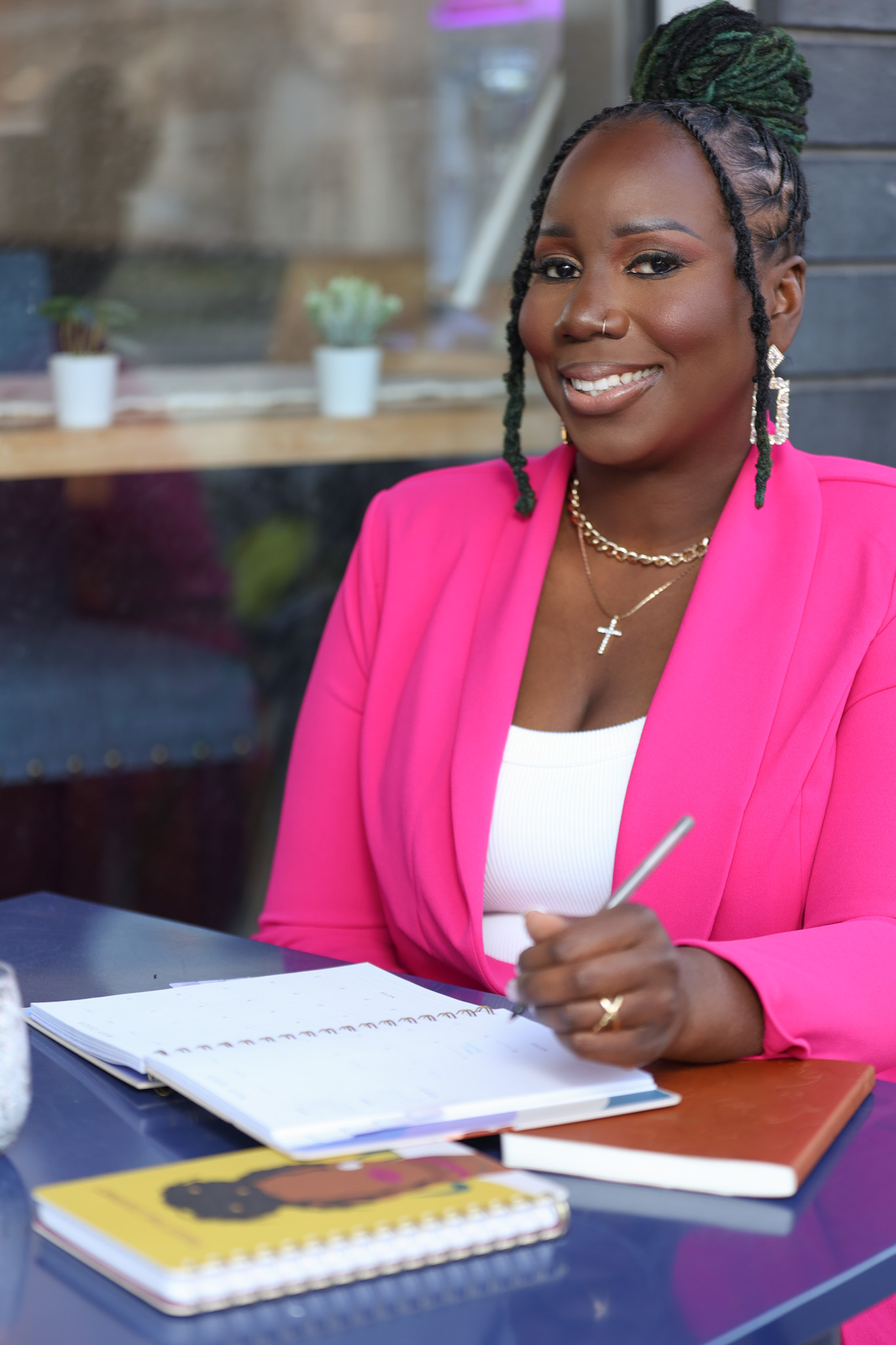 Bre, founder of Klassy Koats Nail Wellness Academy wearing a bright pink blazer
