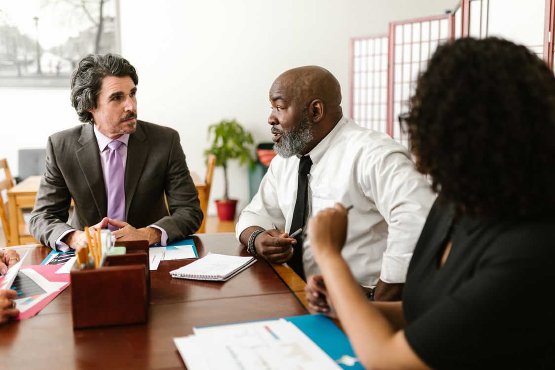 Colleagues having a conversation at work (illustrative stock photo).