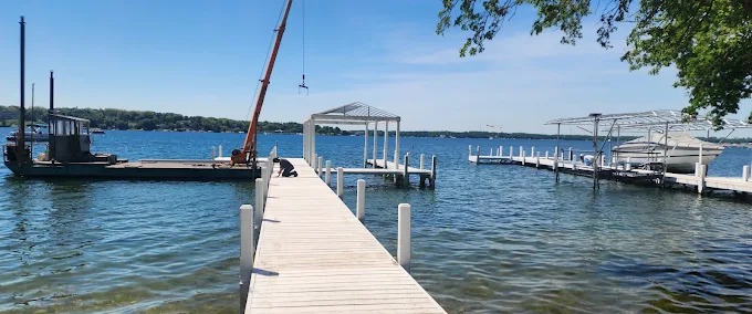 Marine construction work barge and crane setting a dock framework on a Southeast Wisconsin lake