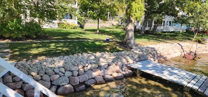 Riprap stone seawall protecting lakefront property and lawn on a Southeast Wisconsin lake