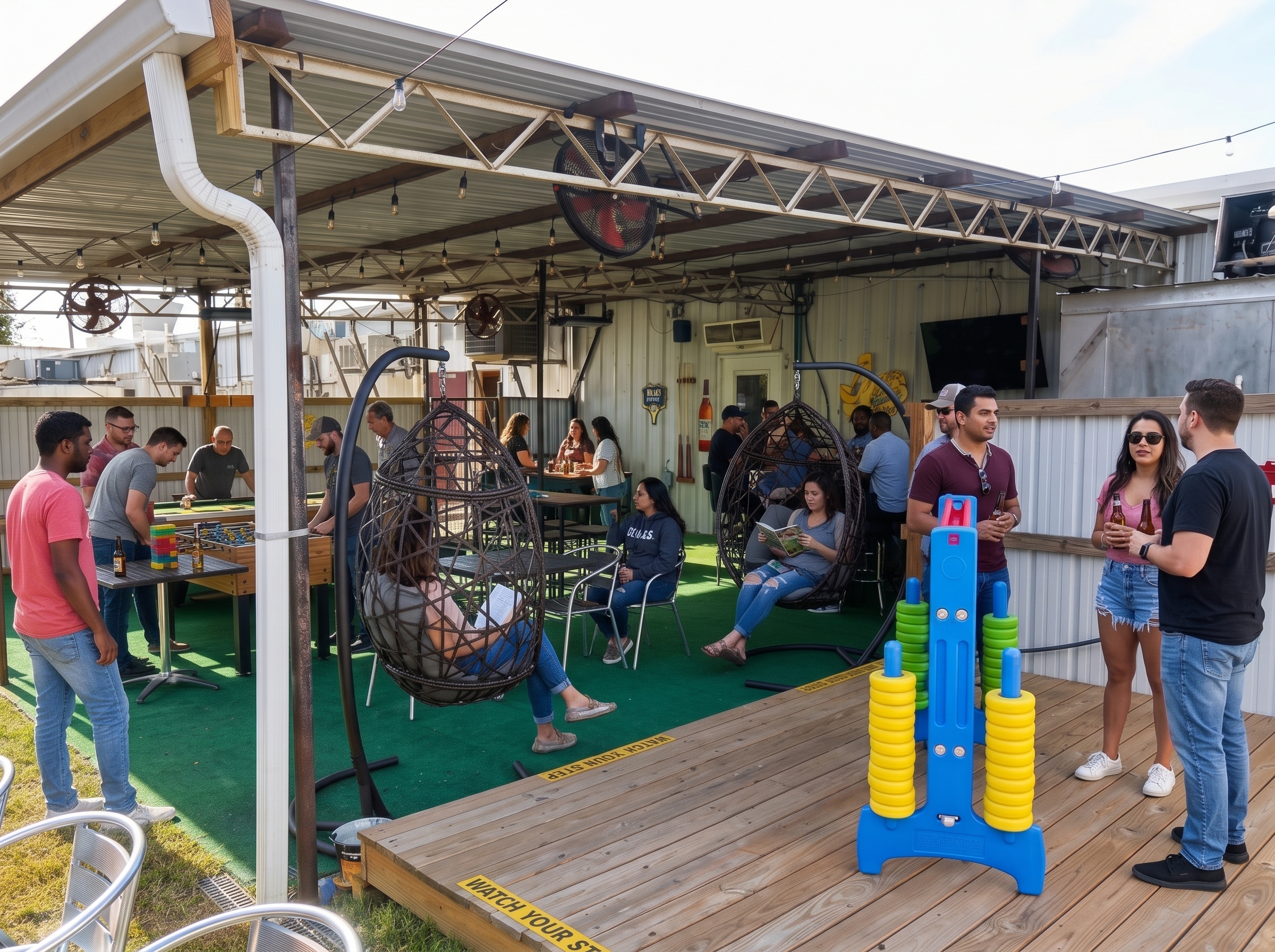 Outdoor covered patio lounge with giant Connect 4, giant Jenga, egg chairs and outdoor pool table