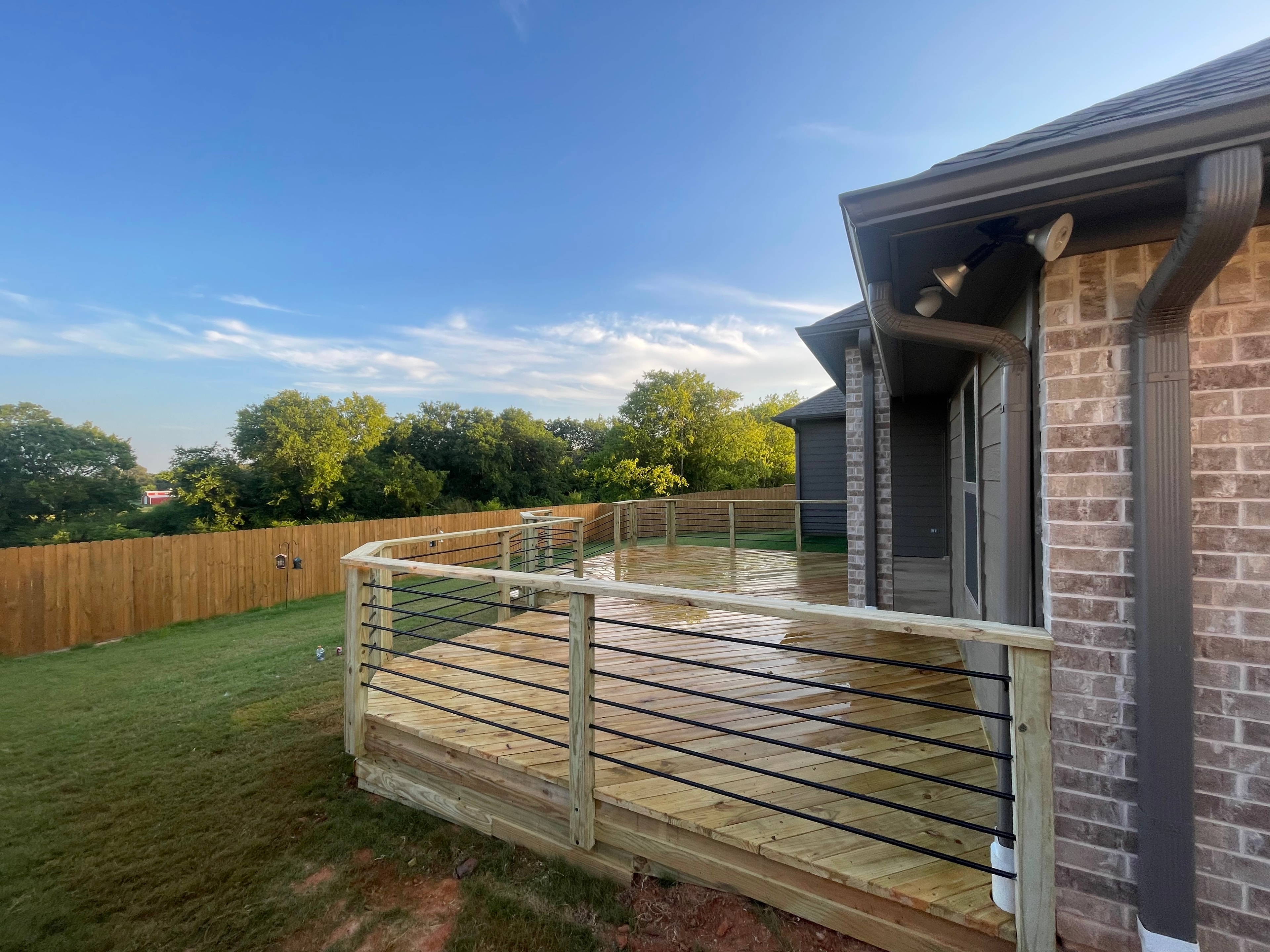 Deck construction with metal railings in East Texas by TW Construction