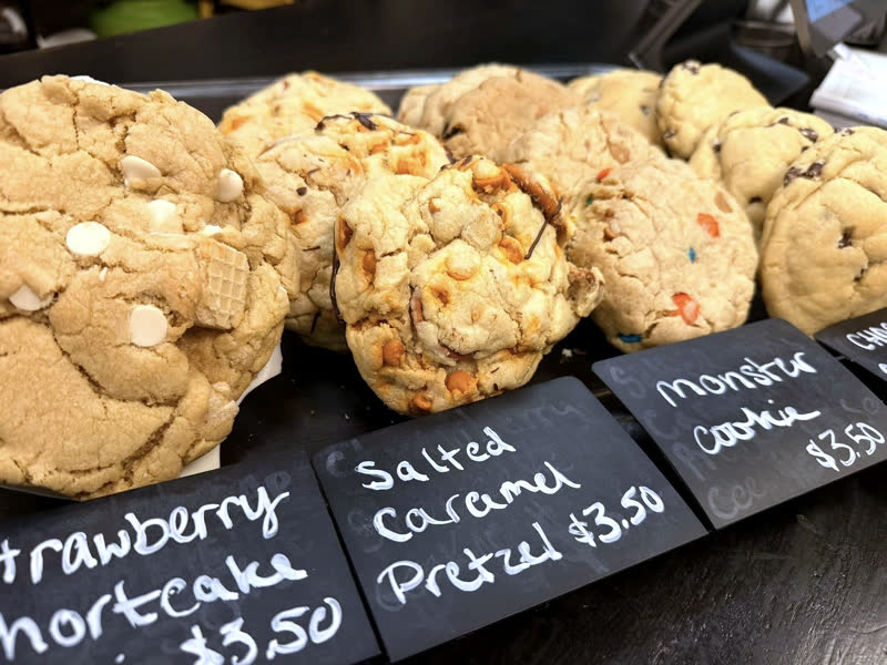 Cookies displayed with handwritten signs.