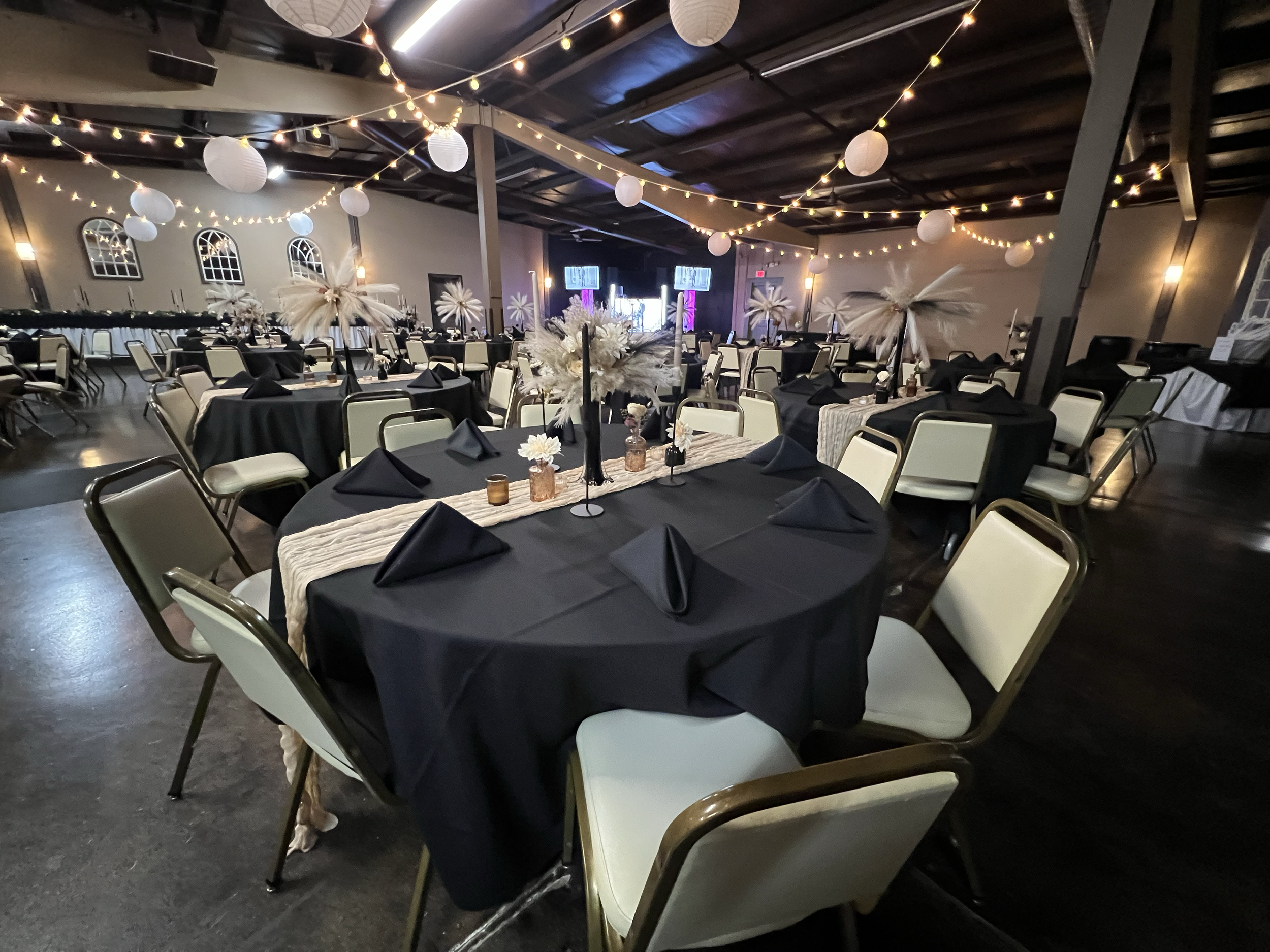 Havelock Social Hall gala setup with round tables and lanterns in Lincoln, NE