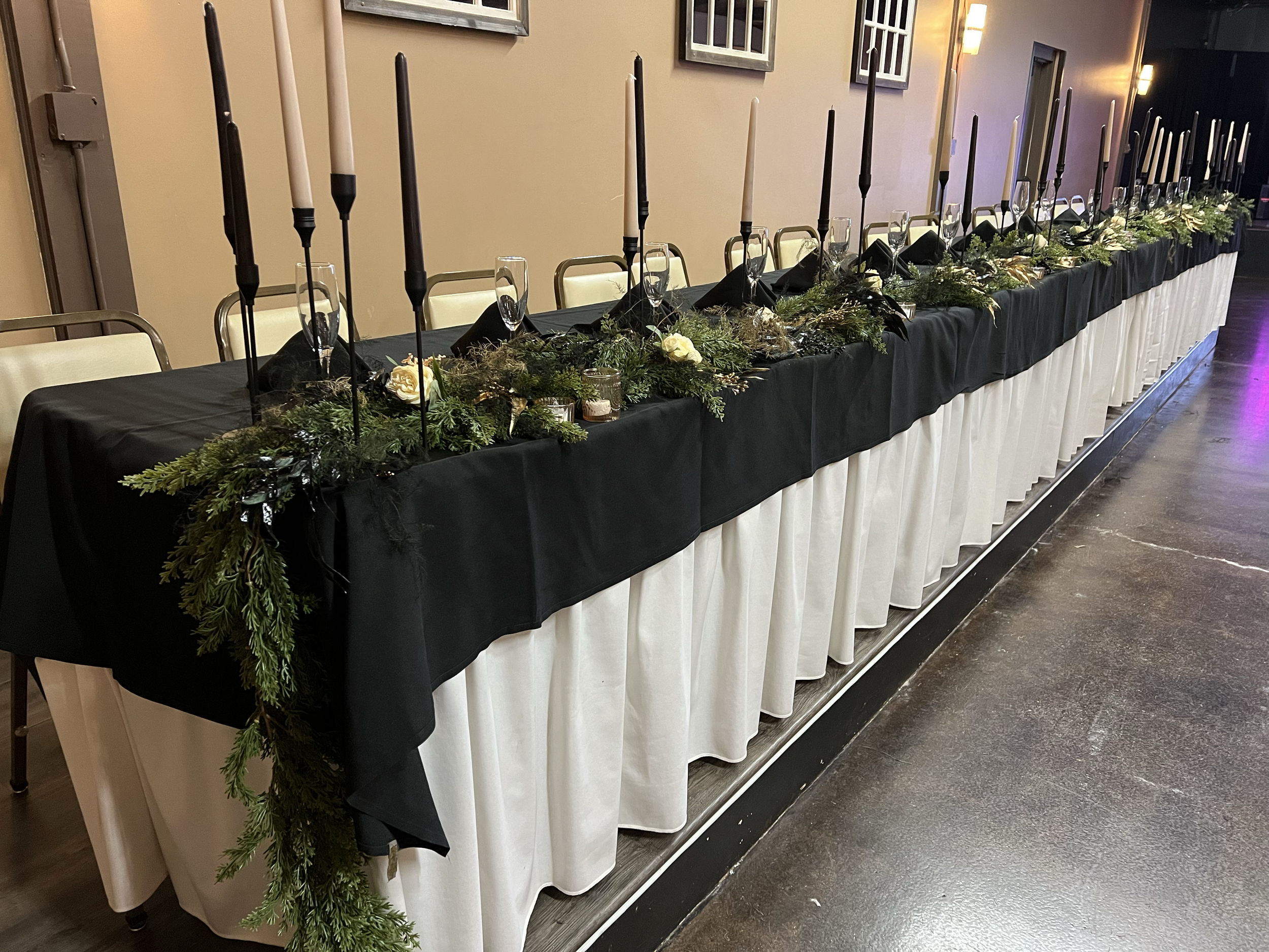 Havelock Social Hall wedding reception head table with greenery and roses in Lincoln, NE