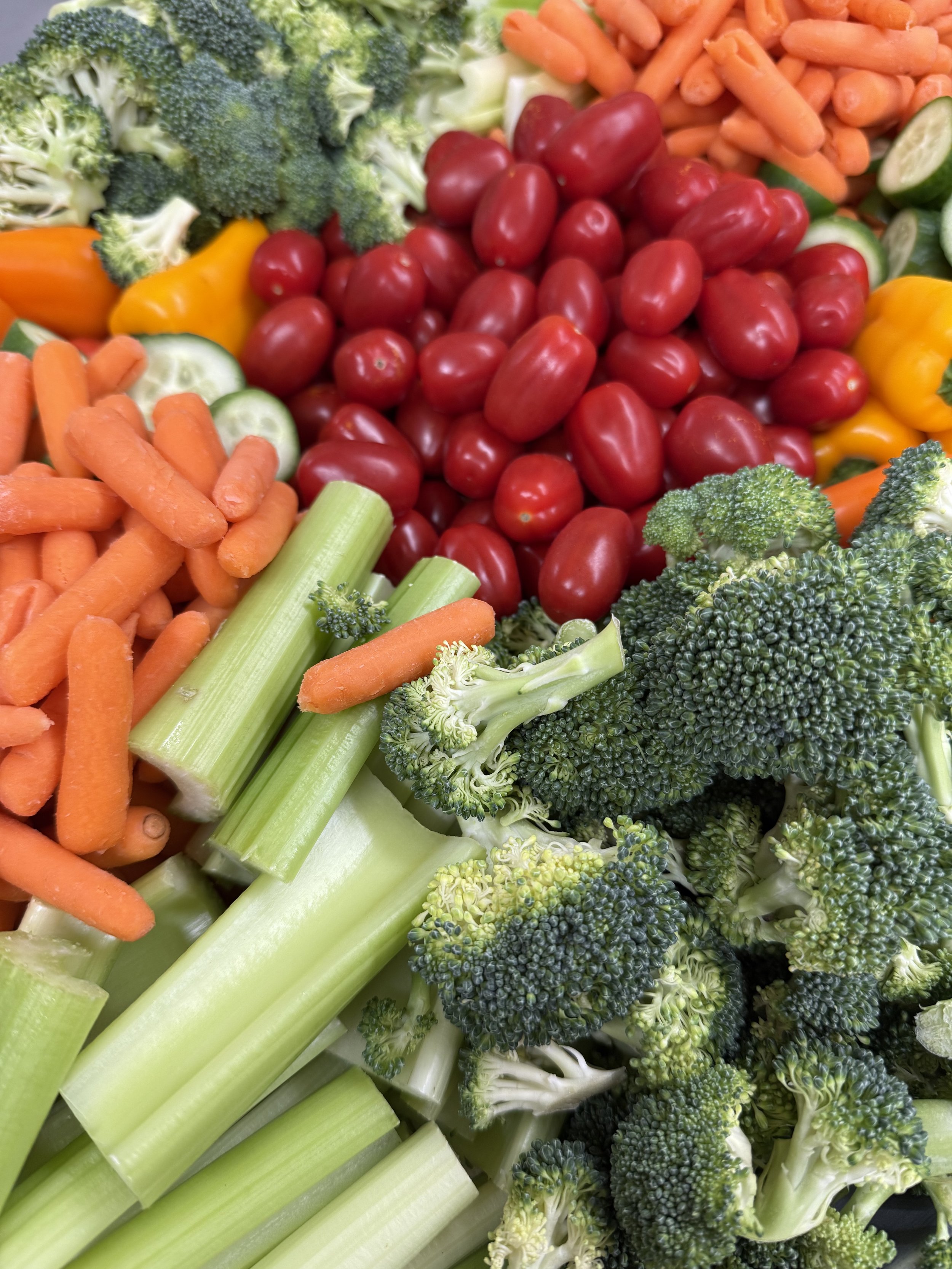 Fresh vegetable platter with carrots, broccoli, and peppers