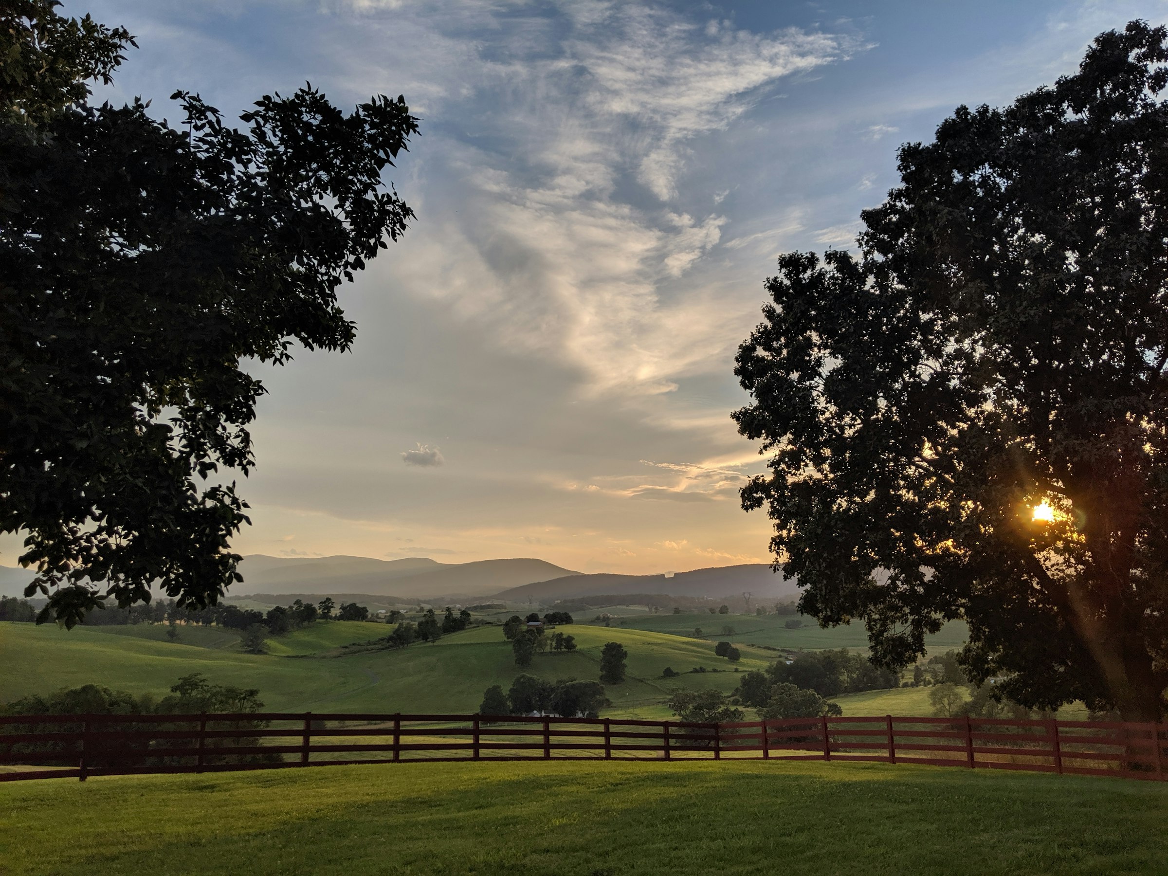 Blue Ridge mountains at sunset over open pasture