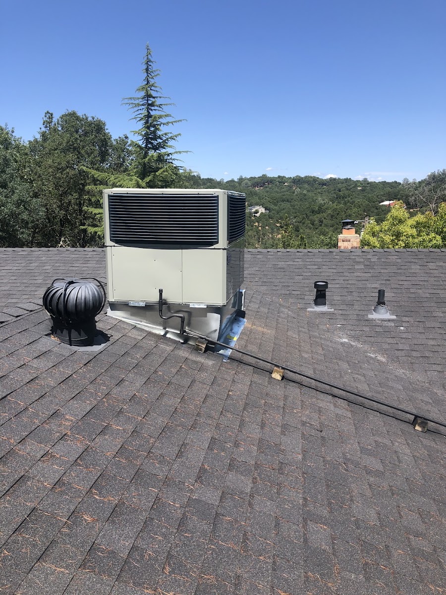 Kimber Heat & Air technician installing a new high-efficiency HVAC system on site