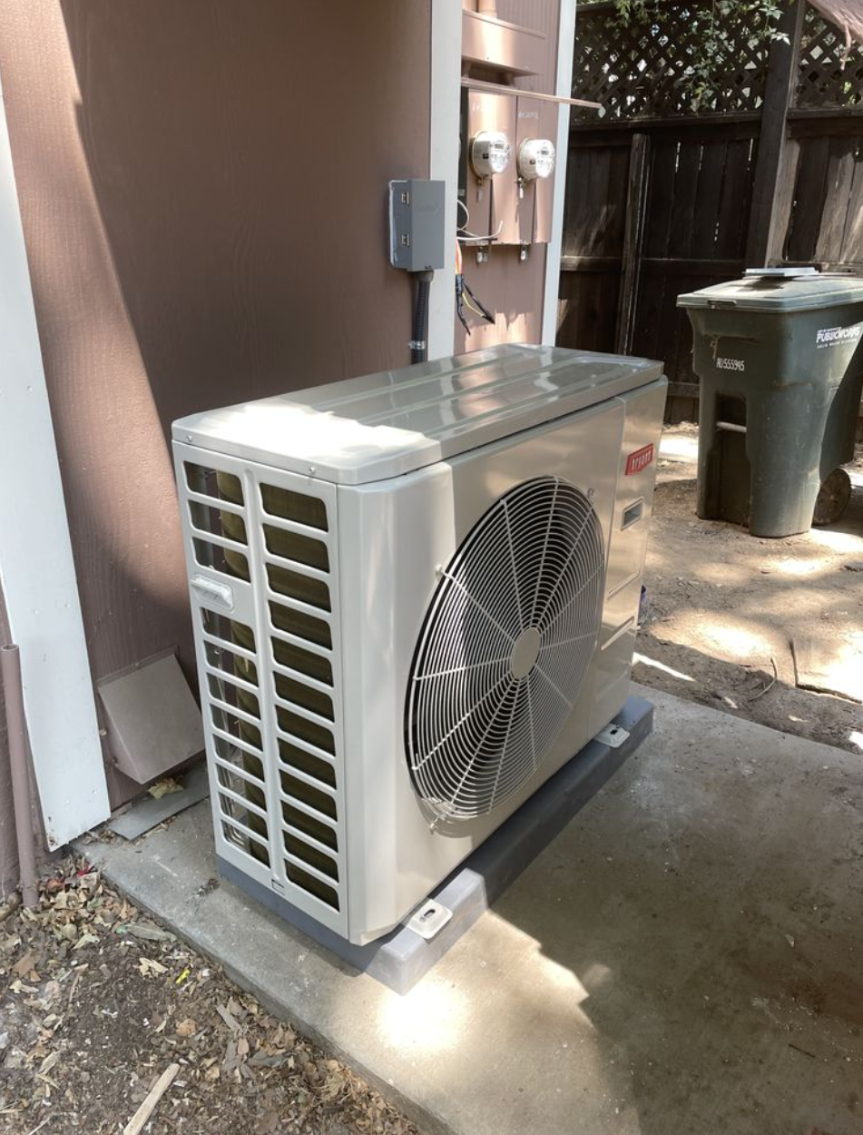Bryant slim inverter heat pump being tuned during seasonal maintenance