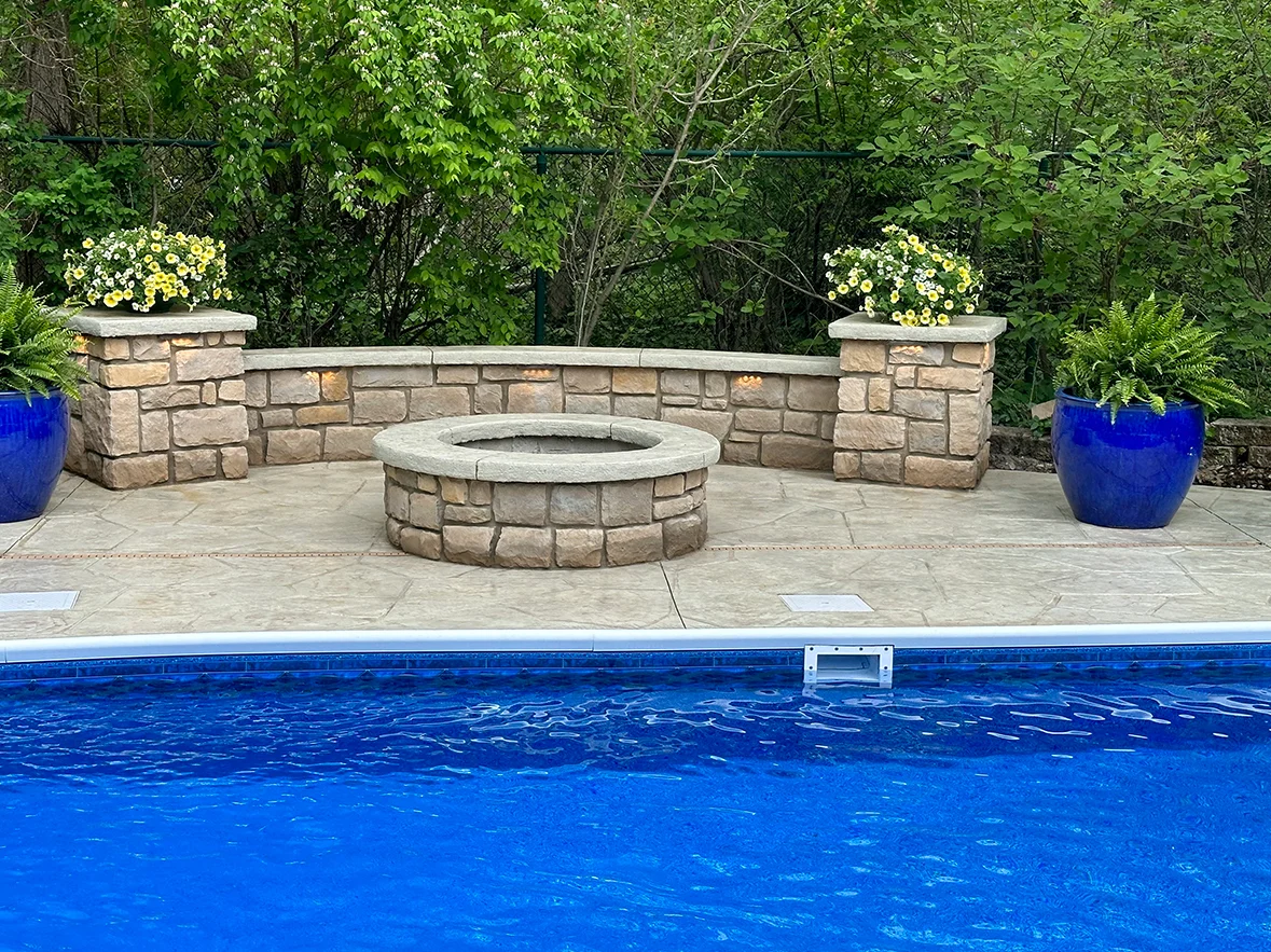 Zionsville Poolside Stamped Deck with Stone Firepit & Curved Seat Wall