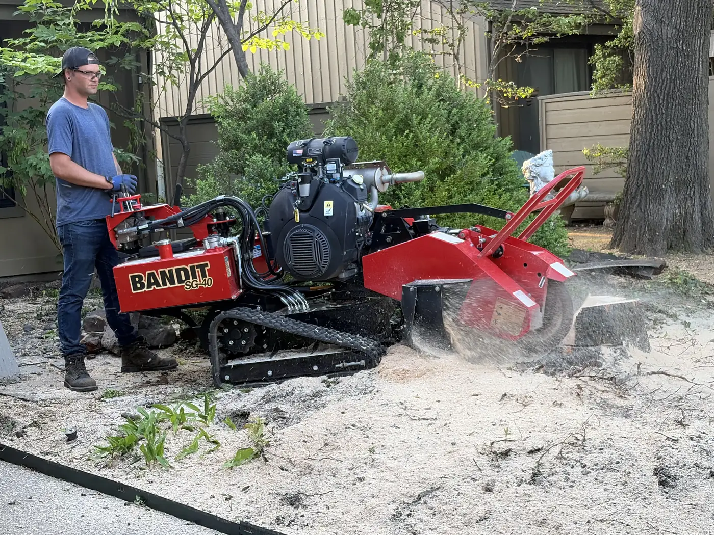 Ironwood Tree Co trimming branches near a home in Tulsa, OK