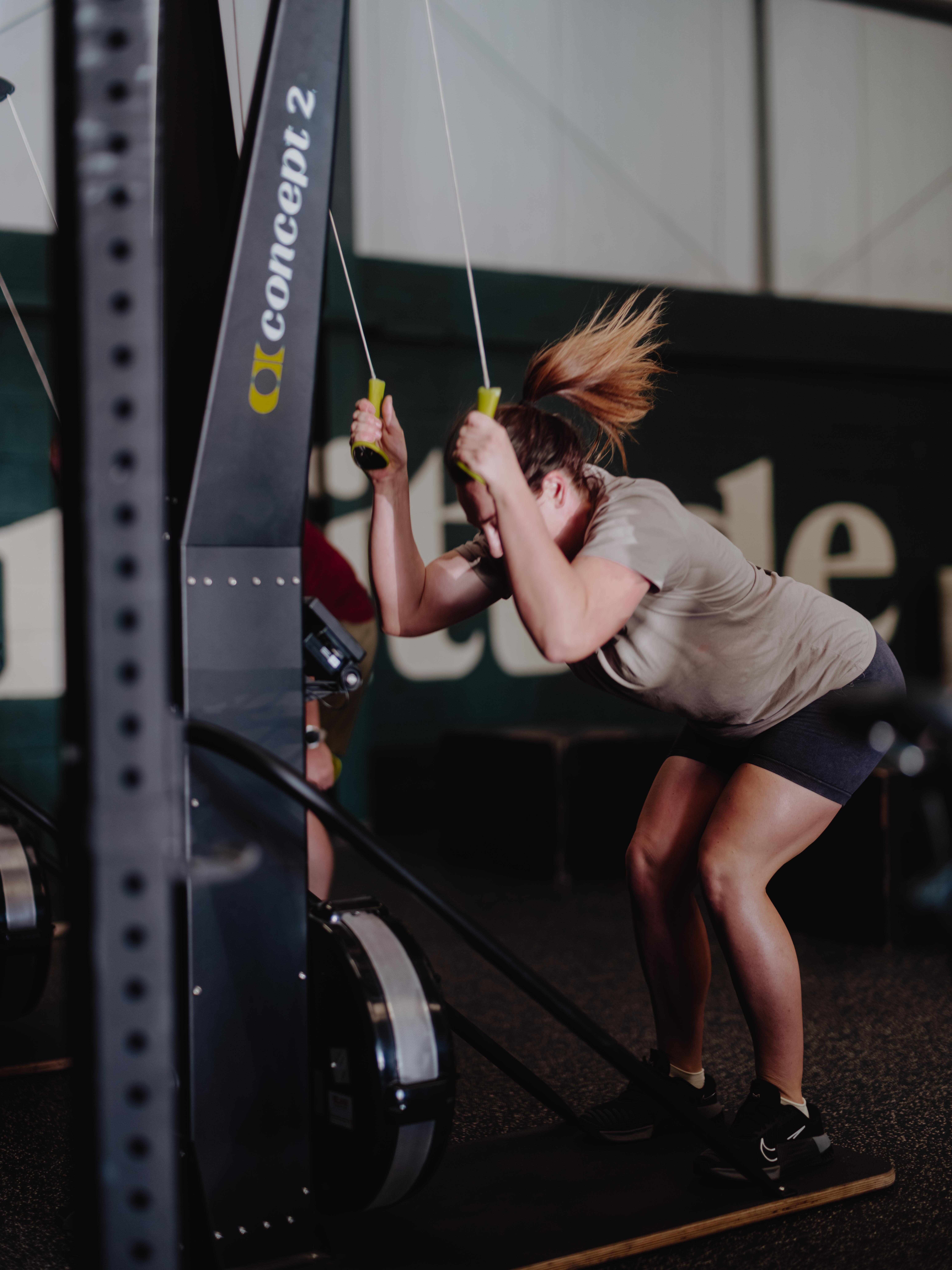 Fortitude members training with barbells and dumbbells in a small group session