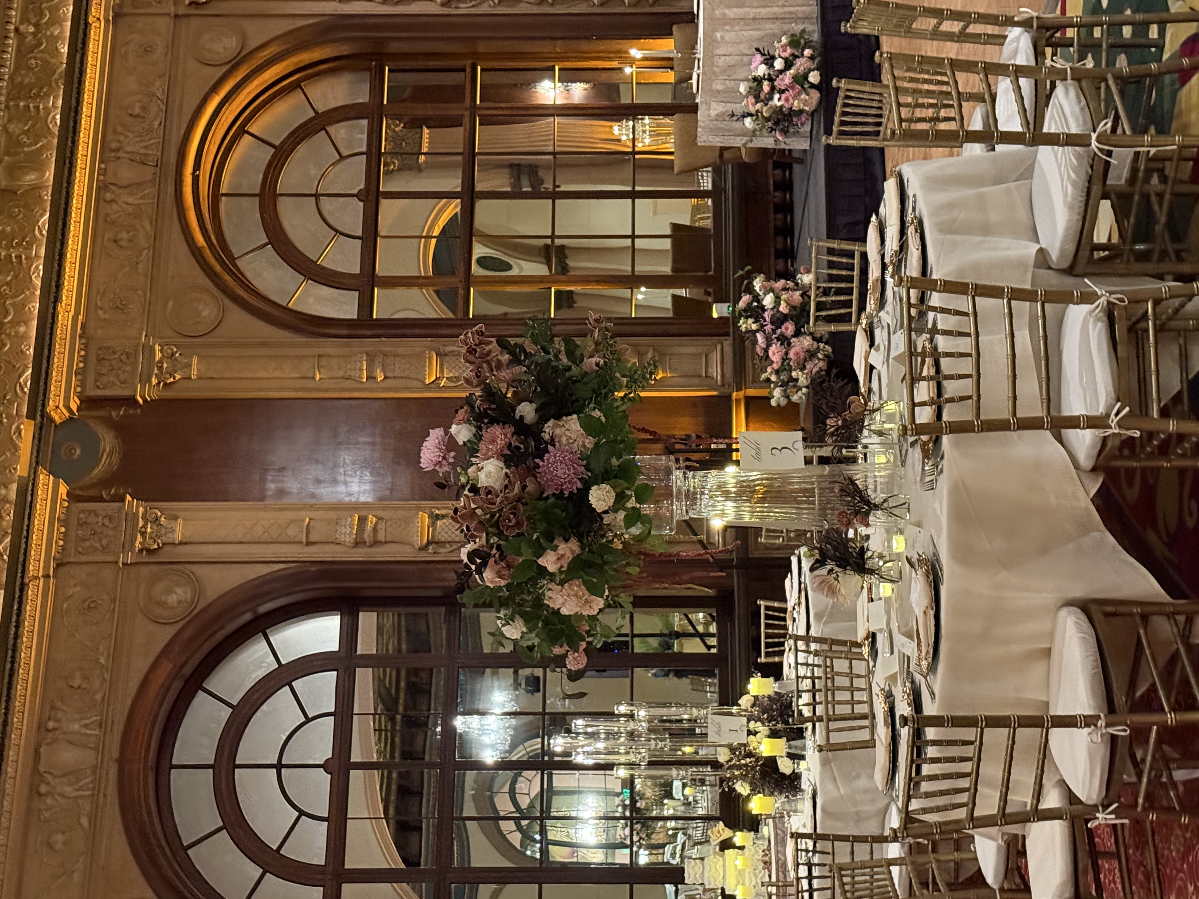 Tall arrangement of mauve chrysanthemums, orchids and roses on crystal pedestal vase in ballroom reception by Soulform Florals, Los Angeles