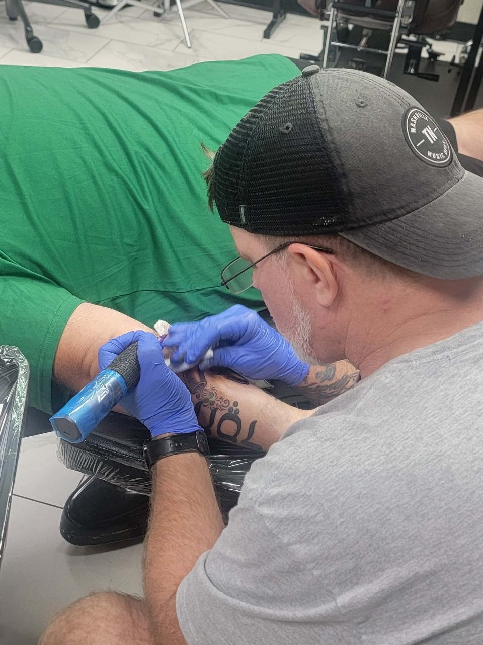 Jason 'Morg' Morgan tattooing client in Muskegon studio