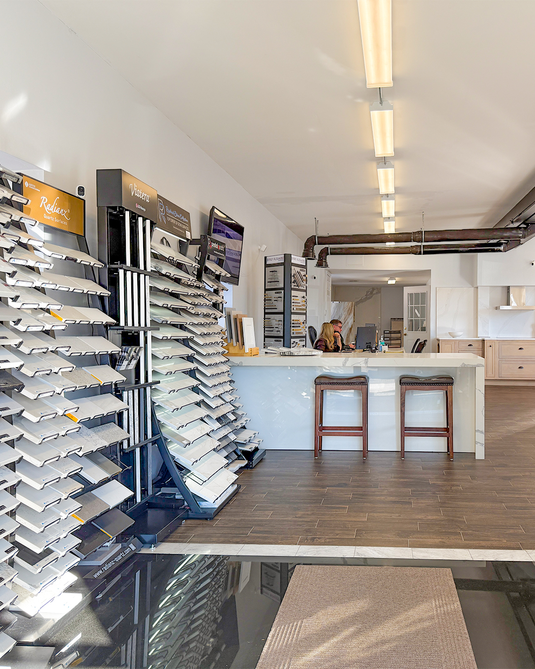 KCC Natick showroom interior with sample towers, reception desk, and team members