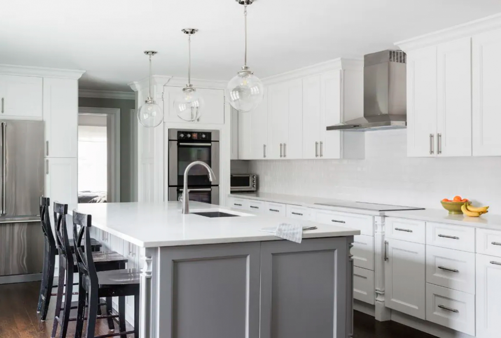 White kitchen remodel with grey island, shaker cabinets and quartz countertops by KCC