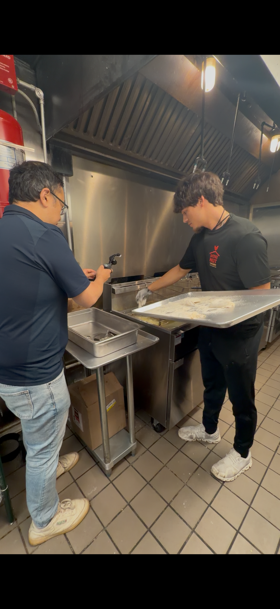 Brett preparing chicken in the Mini Hut kitchen