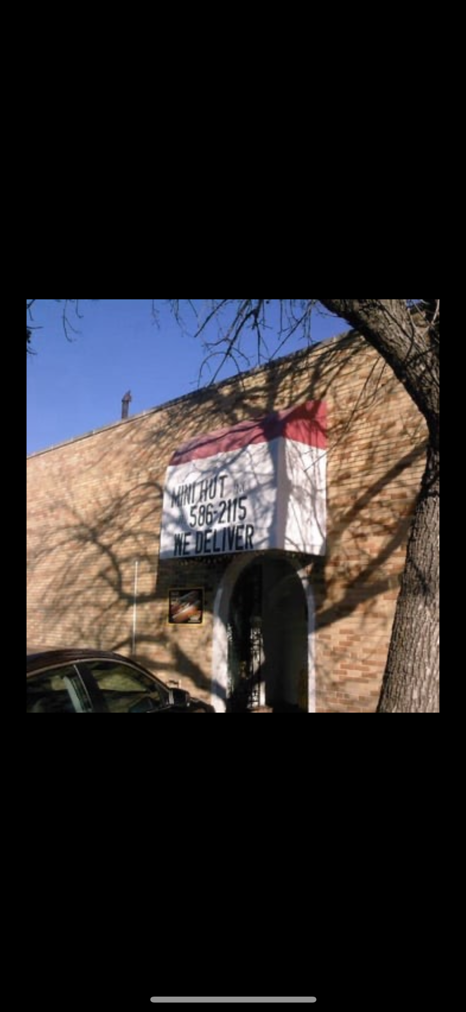 Mini Hut’s former brick storefront with its familiar Mini Hut sign