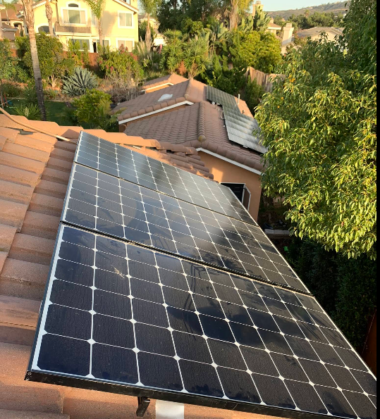 Residential solar panels mounted on clay tile roof