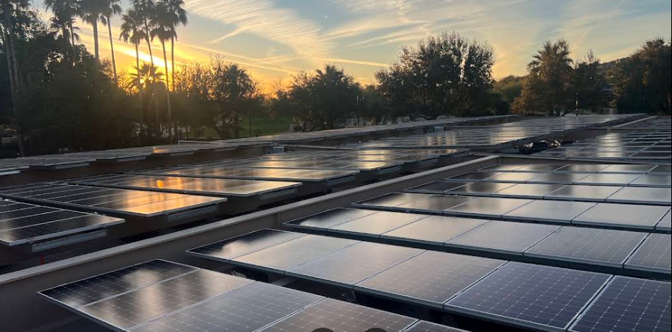 Commercial solar panel array installation at sunset