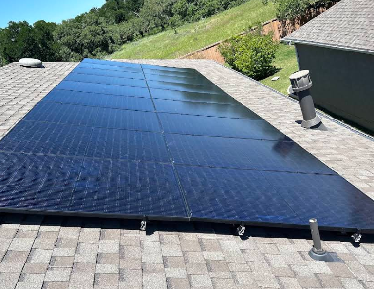 Full residential rooftop solar array installation on shingle roof