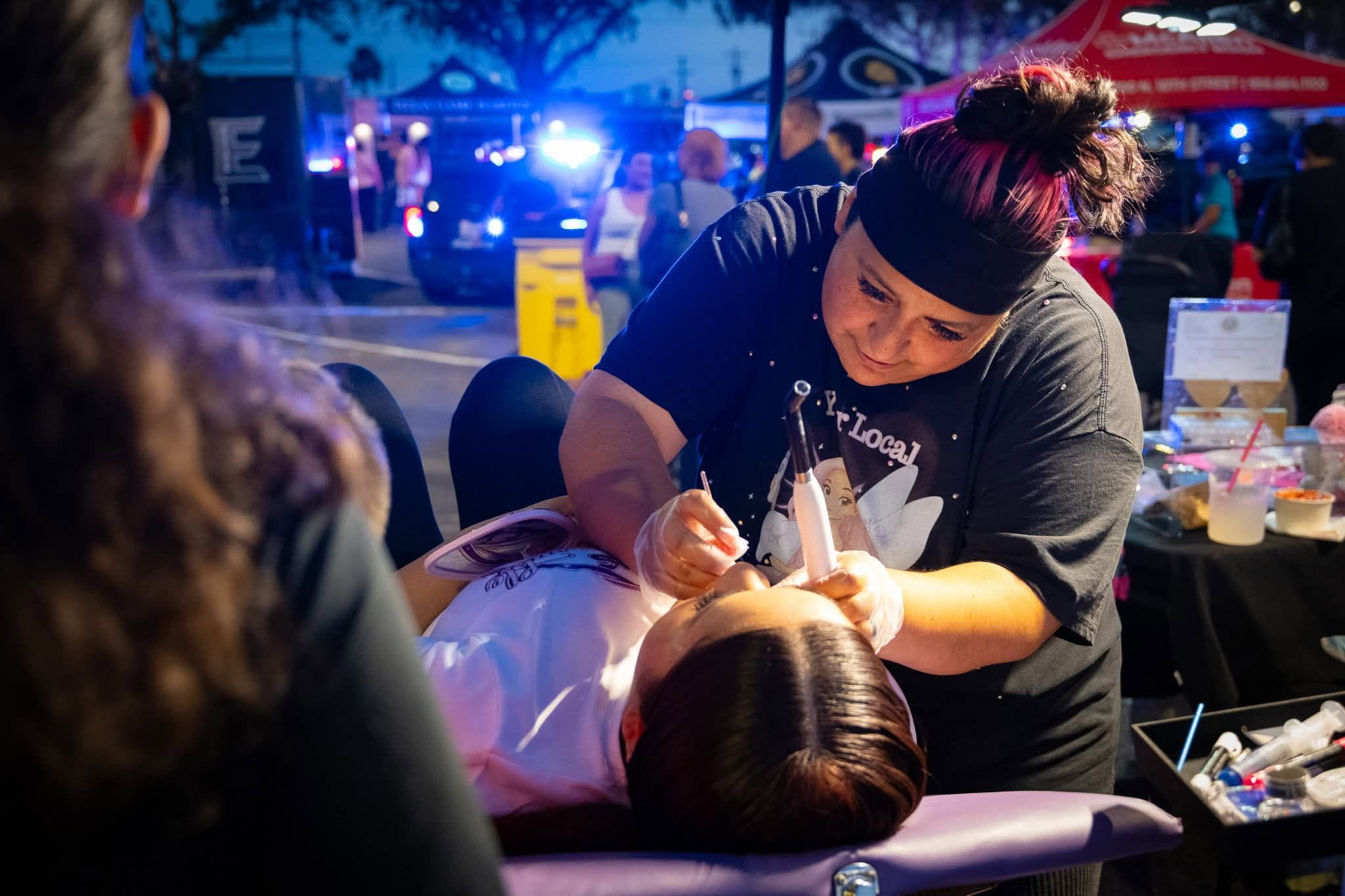 Erika Gonzalez applying tooth gems live at McAllen event pop-up