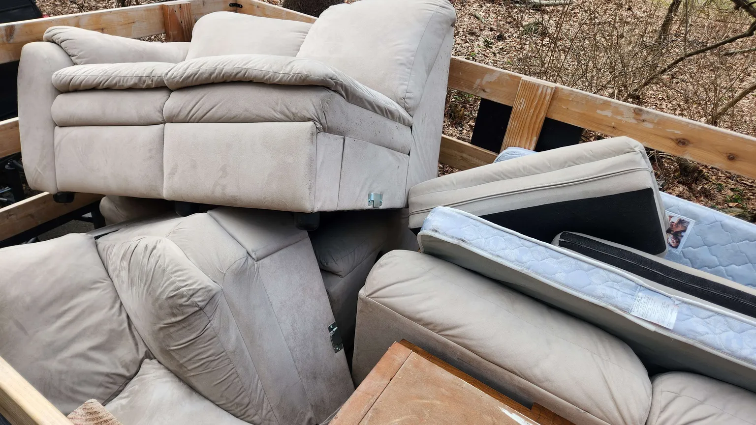 Loaded haul trailer with sofas, mattresses, and bulky household items cleared in Fairfield County