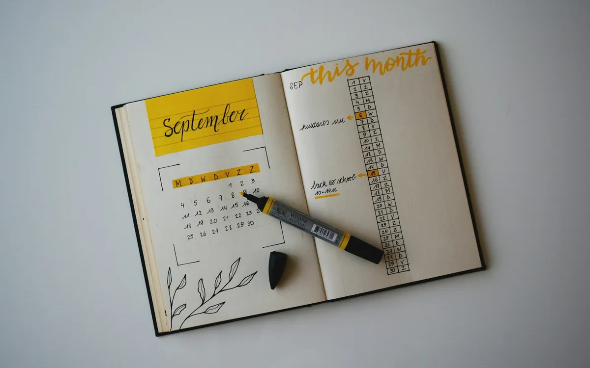 An open hand-drawn calendar with a pen; illustrative stock photo