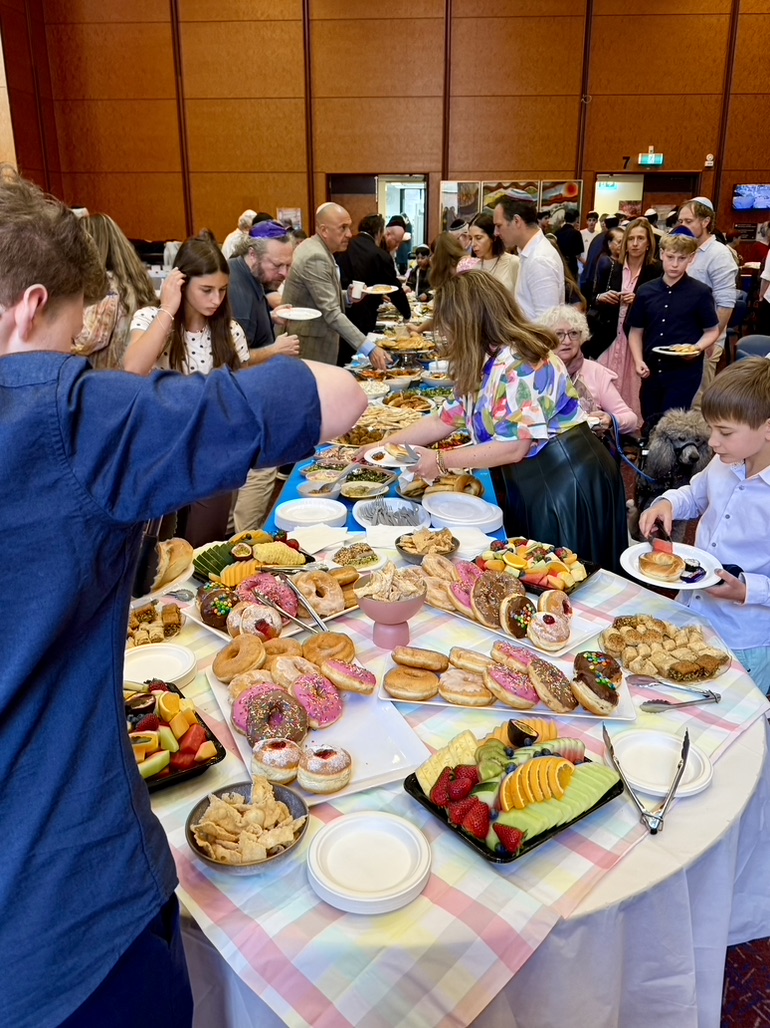Real buffet catering event in Melbourne with guests enjoying a generous spread of food, desserts, pastries and fresh fruit