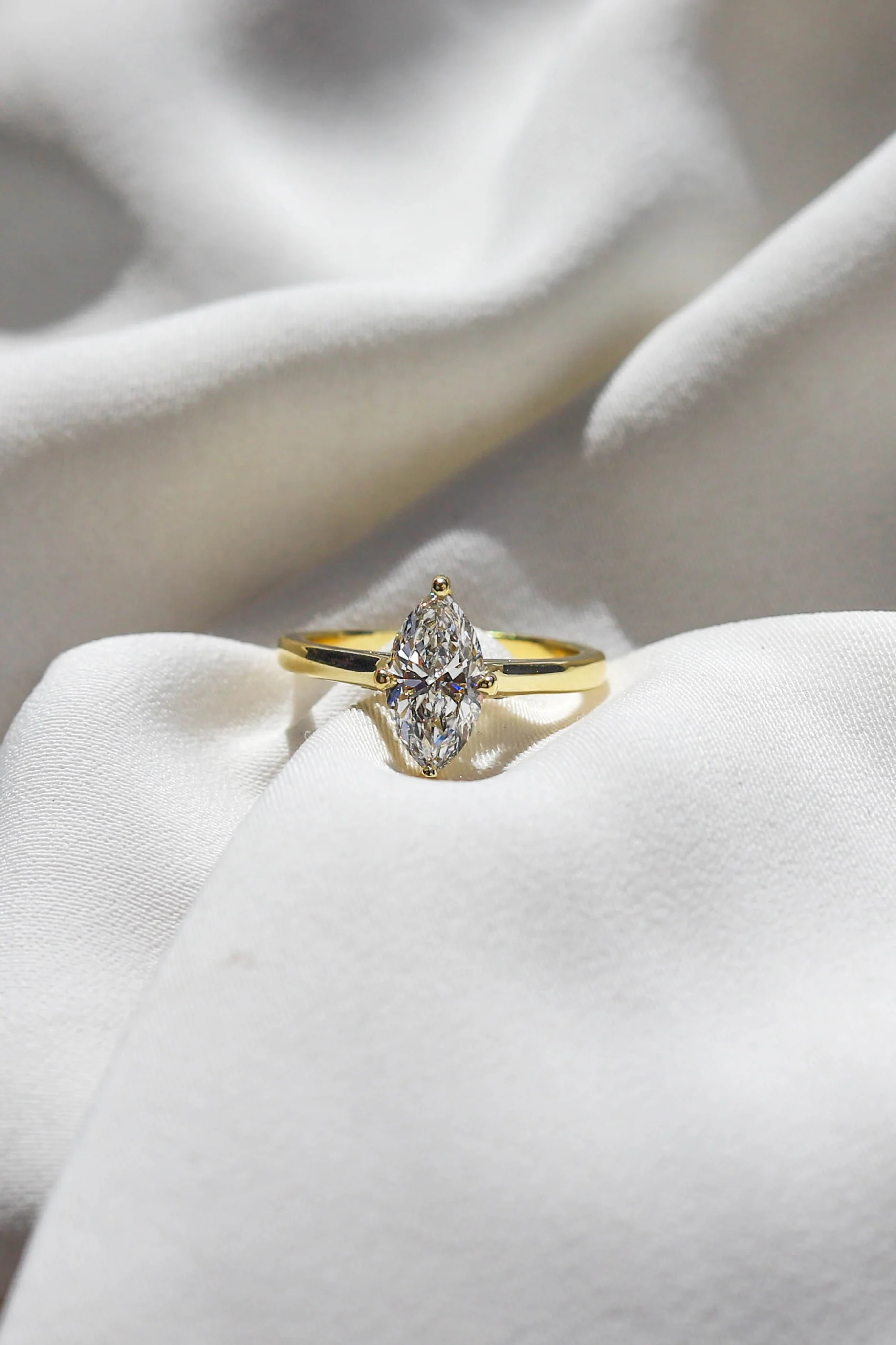 1.00ct lab-grown marquise-cut diamond engagement ring set in warm yellow gold by Beaudell Diamonds